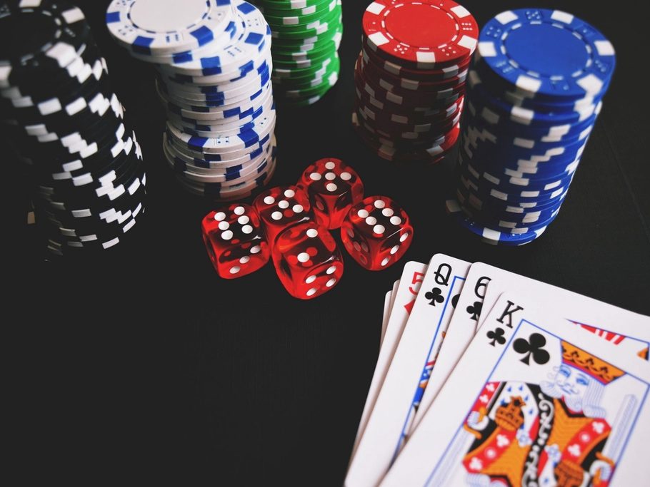 Casino chips, playing cards and dice on a dark table